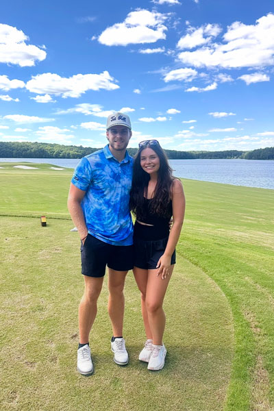 Luke with his girlfriend on golf course